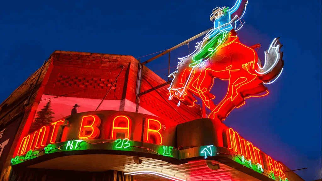 Outside view of neon signs for The Mint Bar in Sheridan, Wyoming - Authentic Things To See And Do In Wyoming