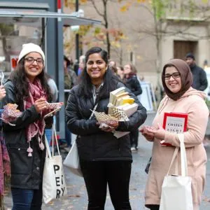 People at the Portland Book Festival browsing books