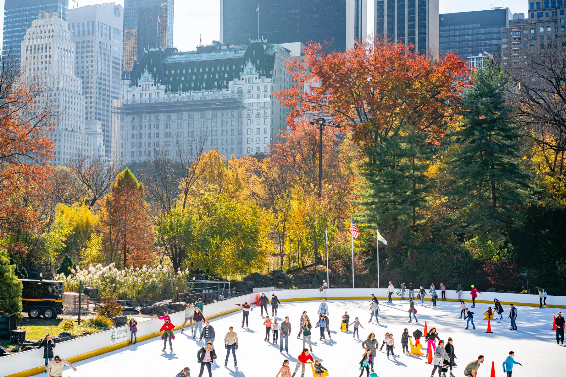 People enjoying ice skating at Wollman Rink in Central Park, a popular place to go in NYC for Christmas