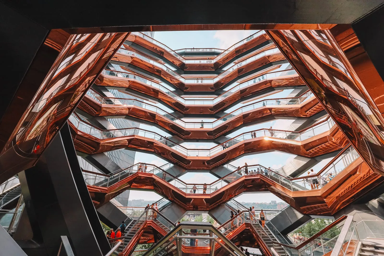 People exploring the intricate staircase structure inside The Vessel in Manhattan