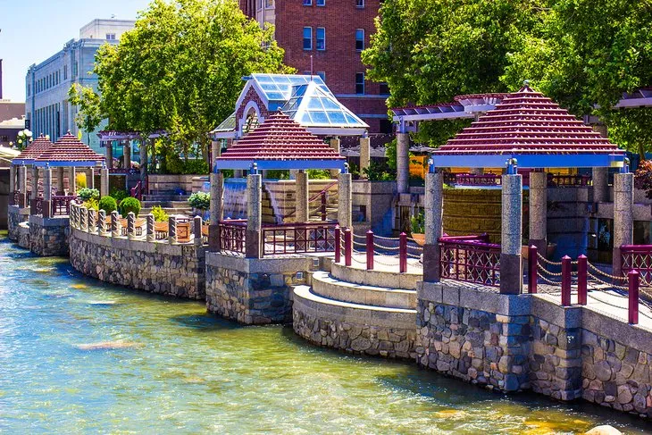 People strolling along the Truckee Riverwalk in downtown Reno's Arts District, a popular area among places to visit in Reno Nevada.