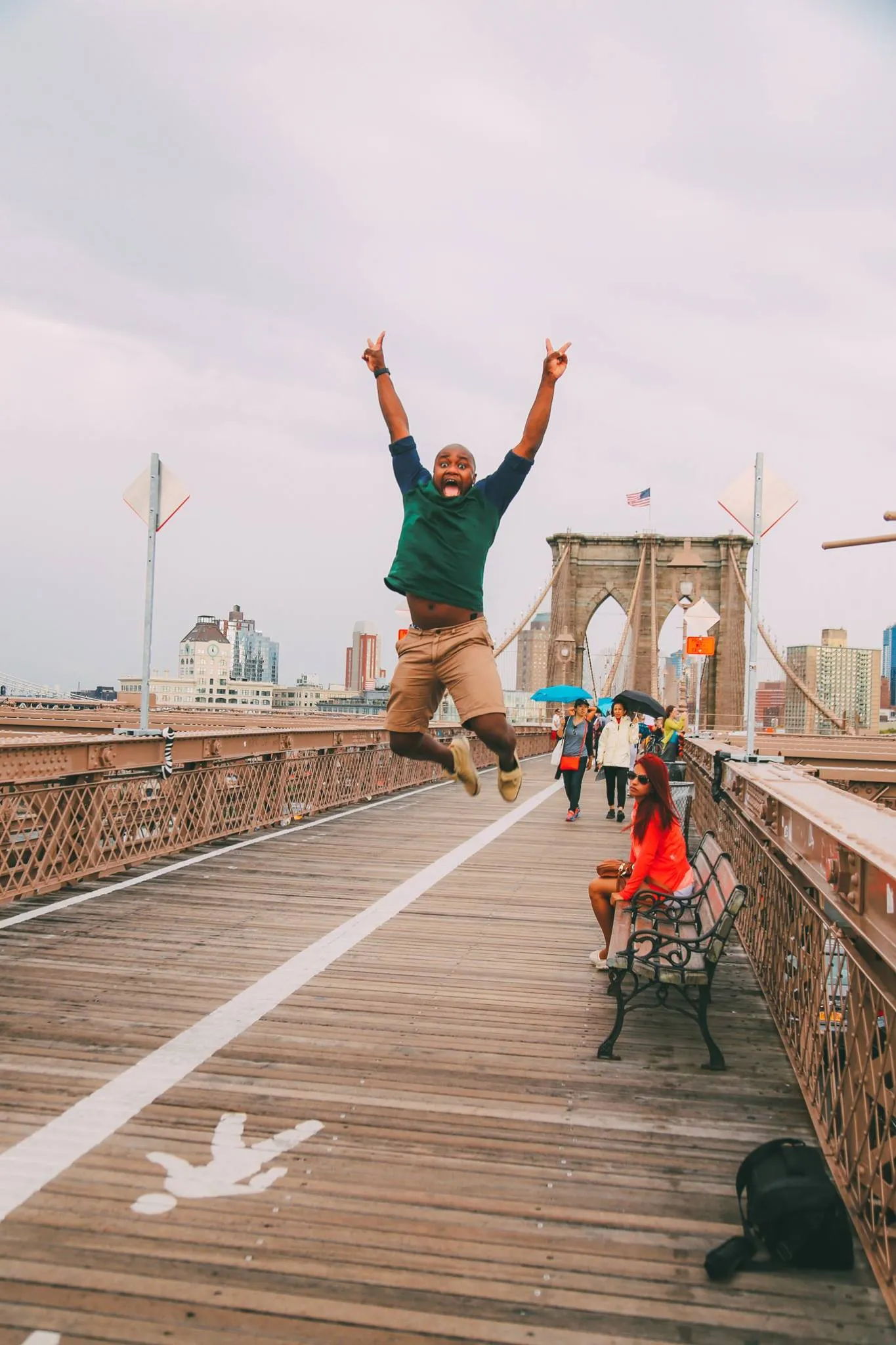 People walking across the historic Brooklyn Bridge, connecting Manhattan and Brooklyn