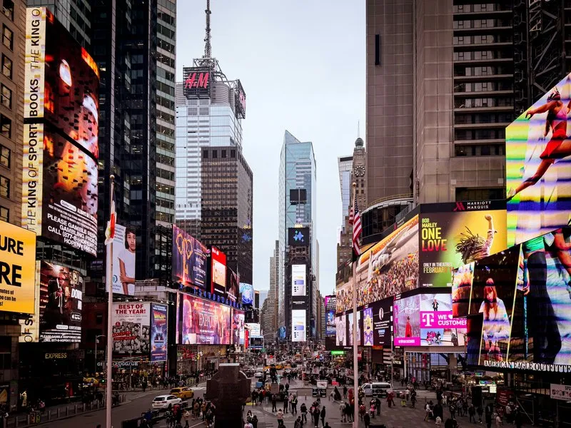 People walking through the pedestrian plaza in Times Square, New York City