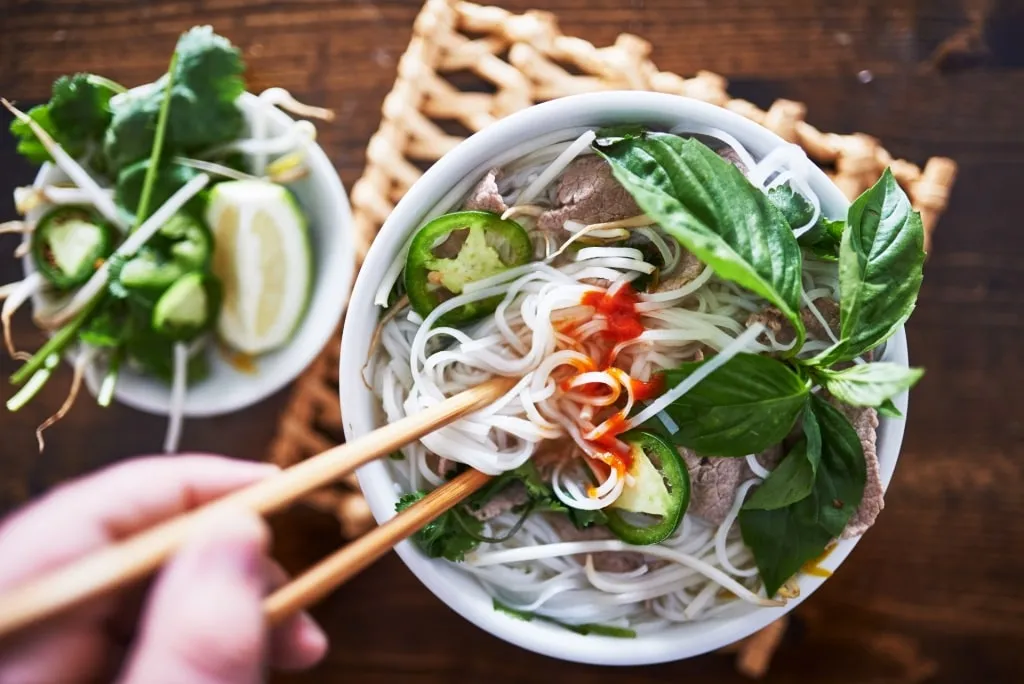 Person eating pho