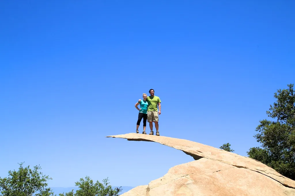 Person standing on the thin, cantilevered Potato Chip Rock formation