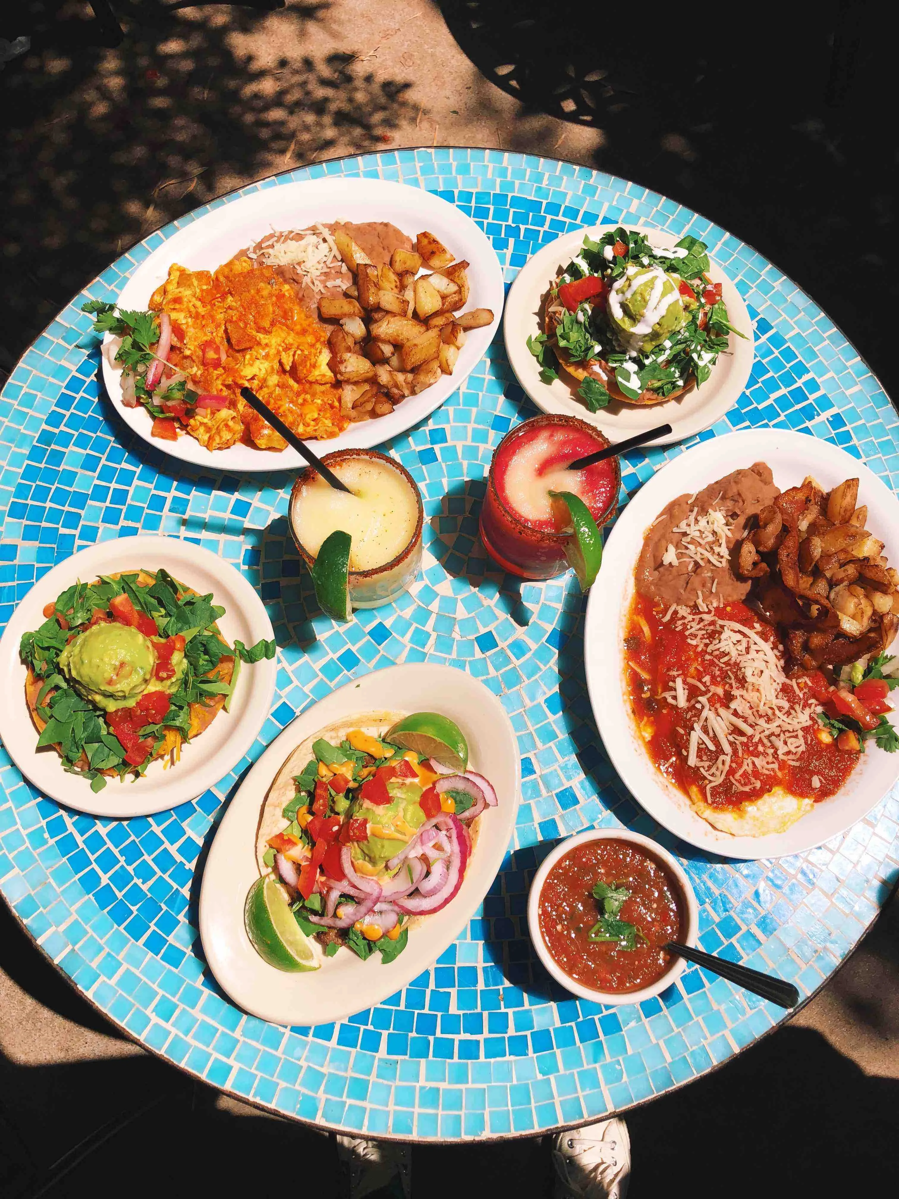 Plate of tamales with sauce and rice at Tamale House East in Austin