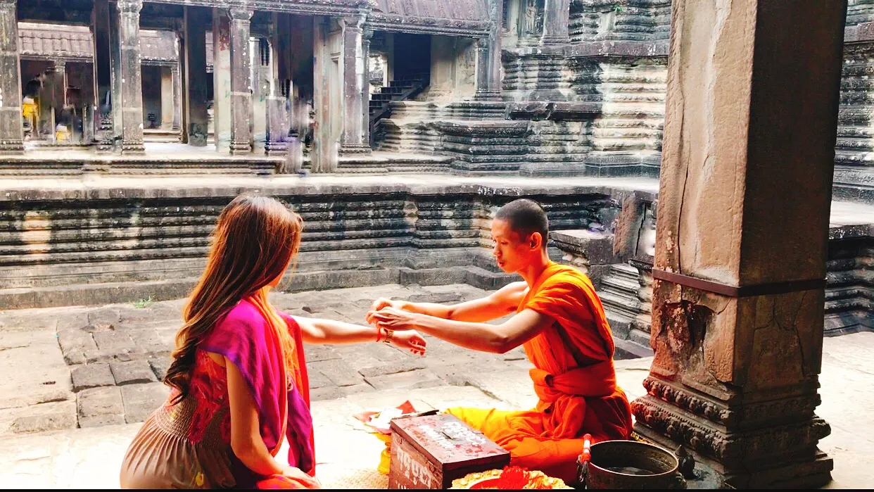 Receiving a blessing from a Buddhist monk near Angkor Wat, Cambodia