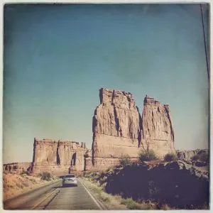 Red rock Courthouse Towers stand tall in Arches National Park, a sight for the girl from road trip