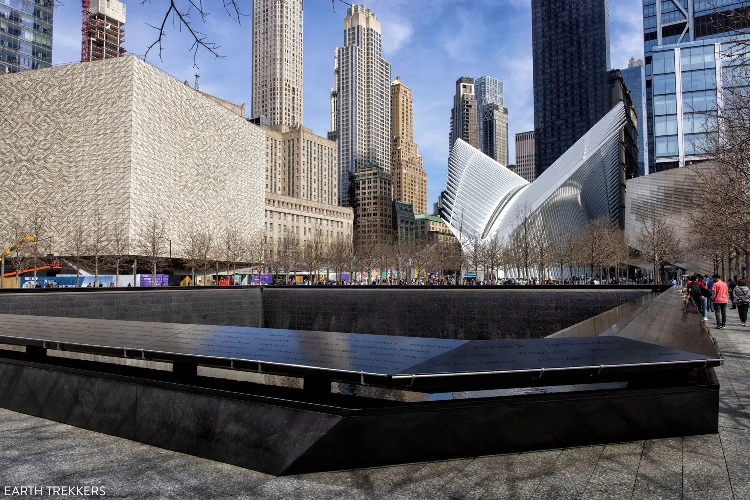 Reflecting pools at the 9/11 Memorial Plaza with the Oculus building in the background