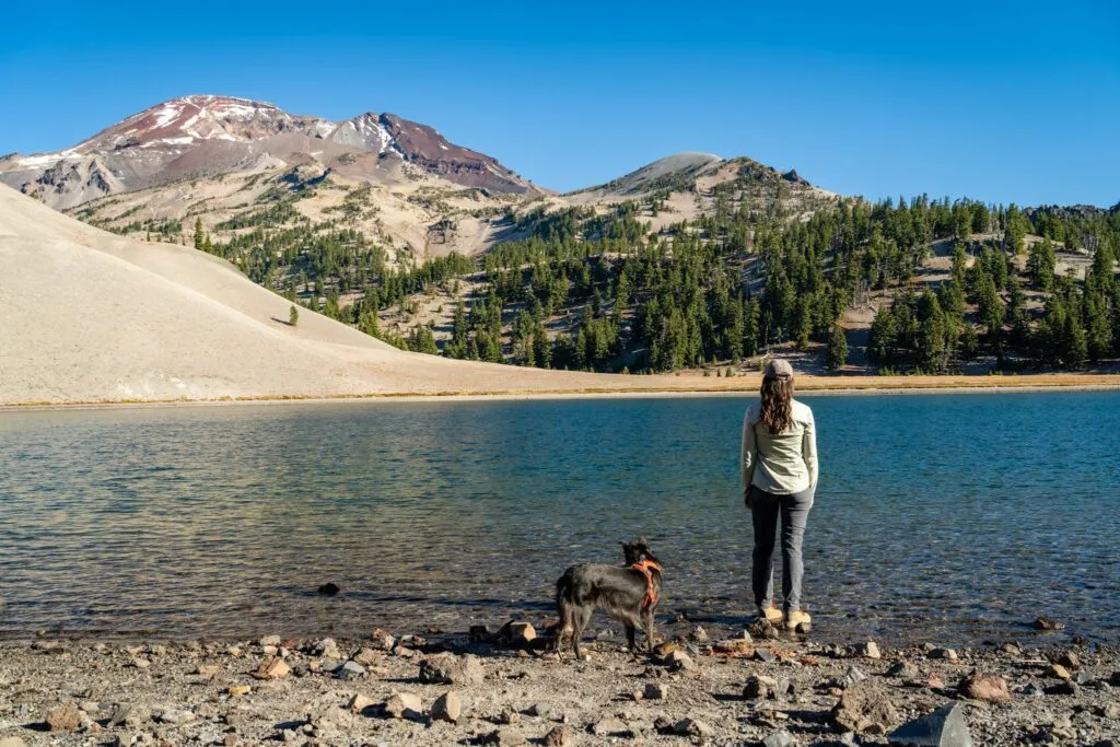 Relaxing by the clear waters of Moraine Lake at the base of South Sister peak
