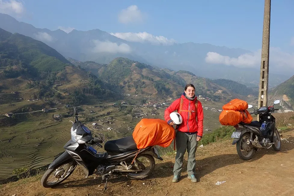 Riding a motorbike along a scenic mountain road on the Ha Giang Loop, Vietnam.
