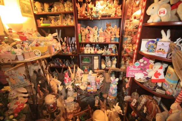 Room filled with shelves and displays of bunny figurines and collectibles