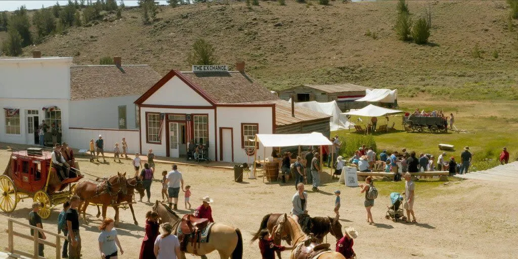 Row of historic buildings with horses and carriage at the ghost town of South Pass City - Things To See And Do In Wyoming History