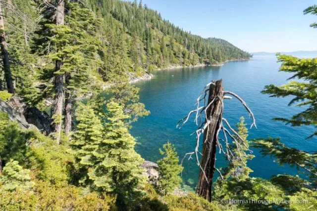 Rubicon Trail winds along the rocky shoreline of Lake Tahoe with clear blue water