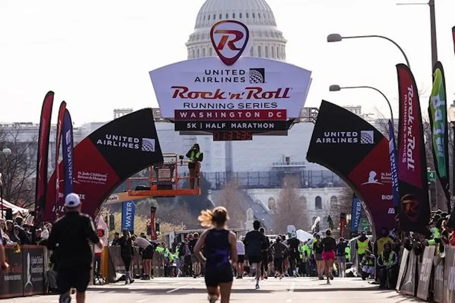 Runners approaching the finish line of the Rock 'n' Roll Running Series race in Washington DC with the US Capitol in the background