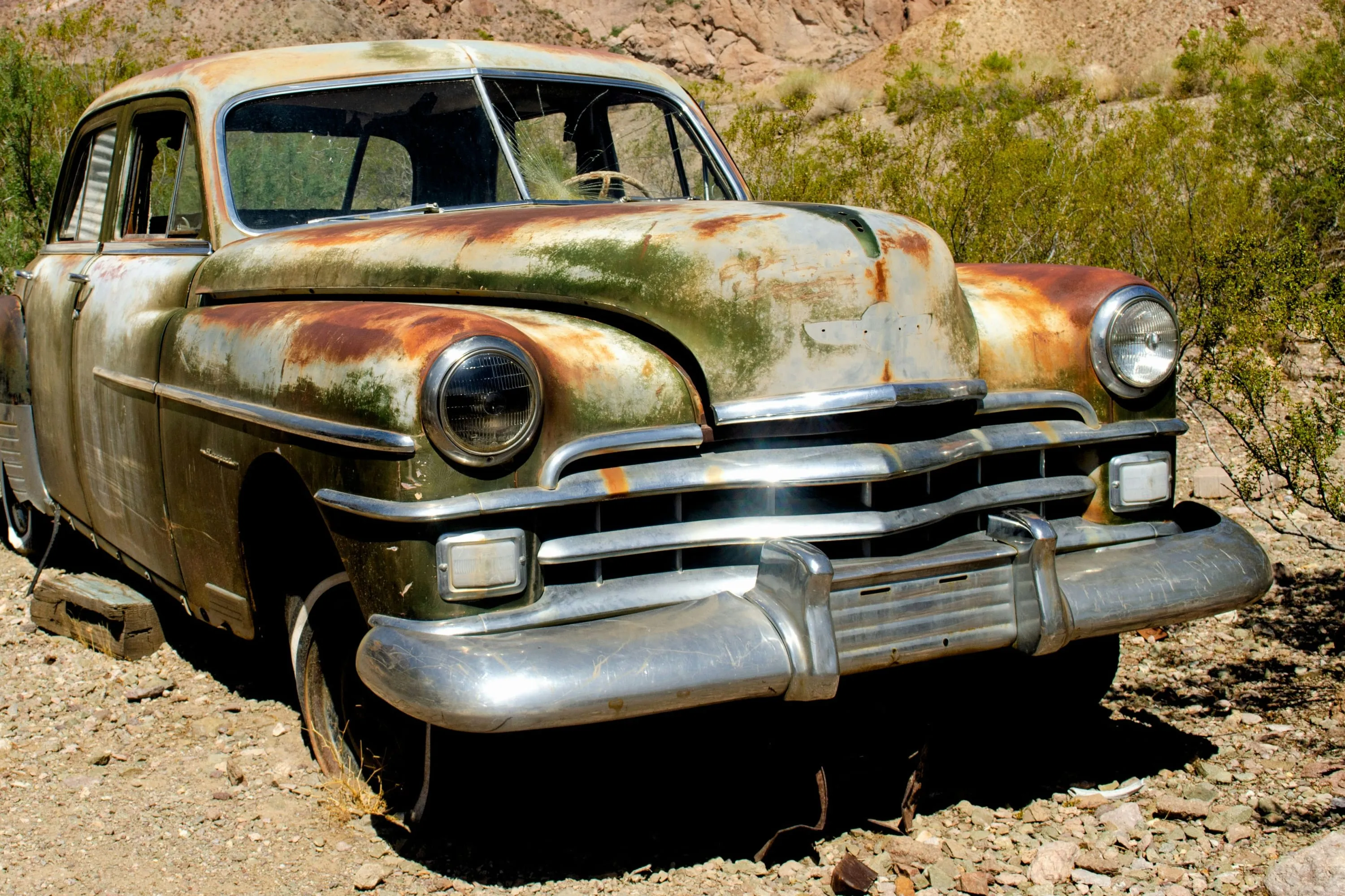 Rusted vintage car in the dry desert landscape of Nelson Ghost Town