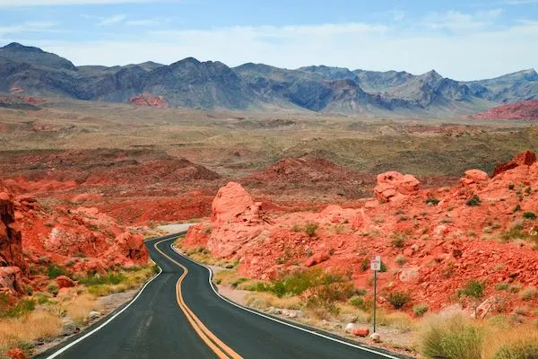 Scenic road winding through vibrant red rock formations in Valley of Fire State Park, Nevada