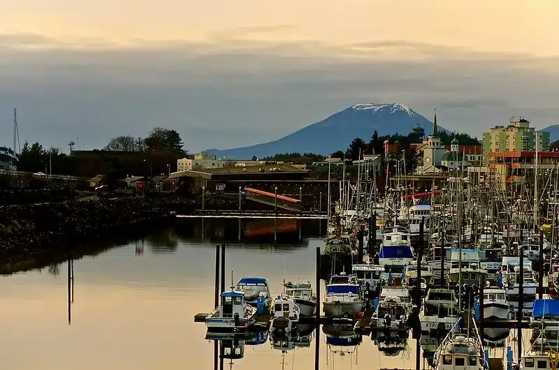 Scenic view of Sitka, Alaska, with mountains, water, and a volcano in the distance