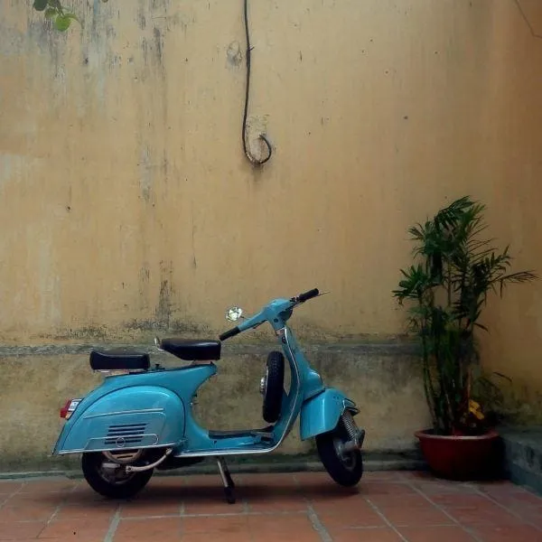 Scooters parked along a street in Hoi An, depicting daily life in the town