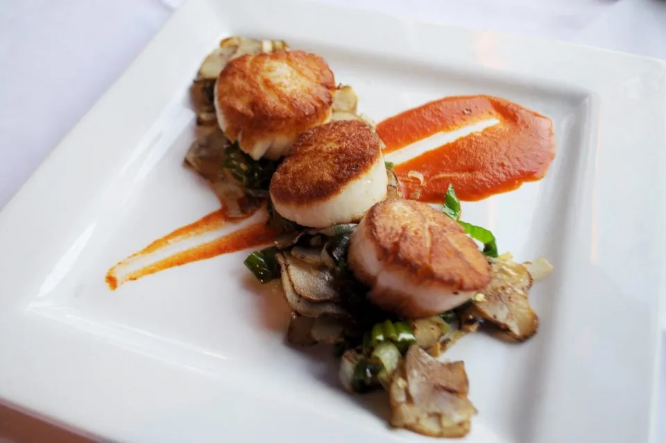Seared scallops plated at MacKenzie's Chop House, a fine dining option in Colorado Springs.