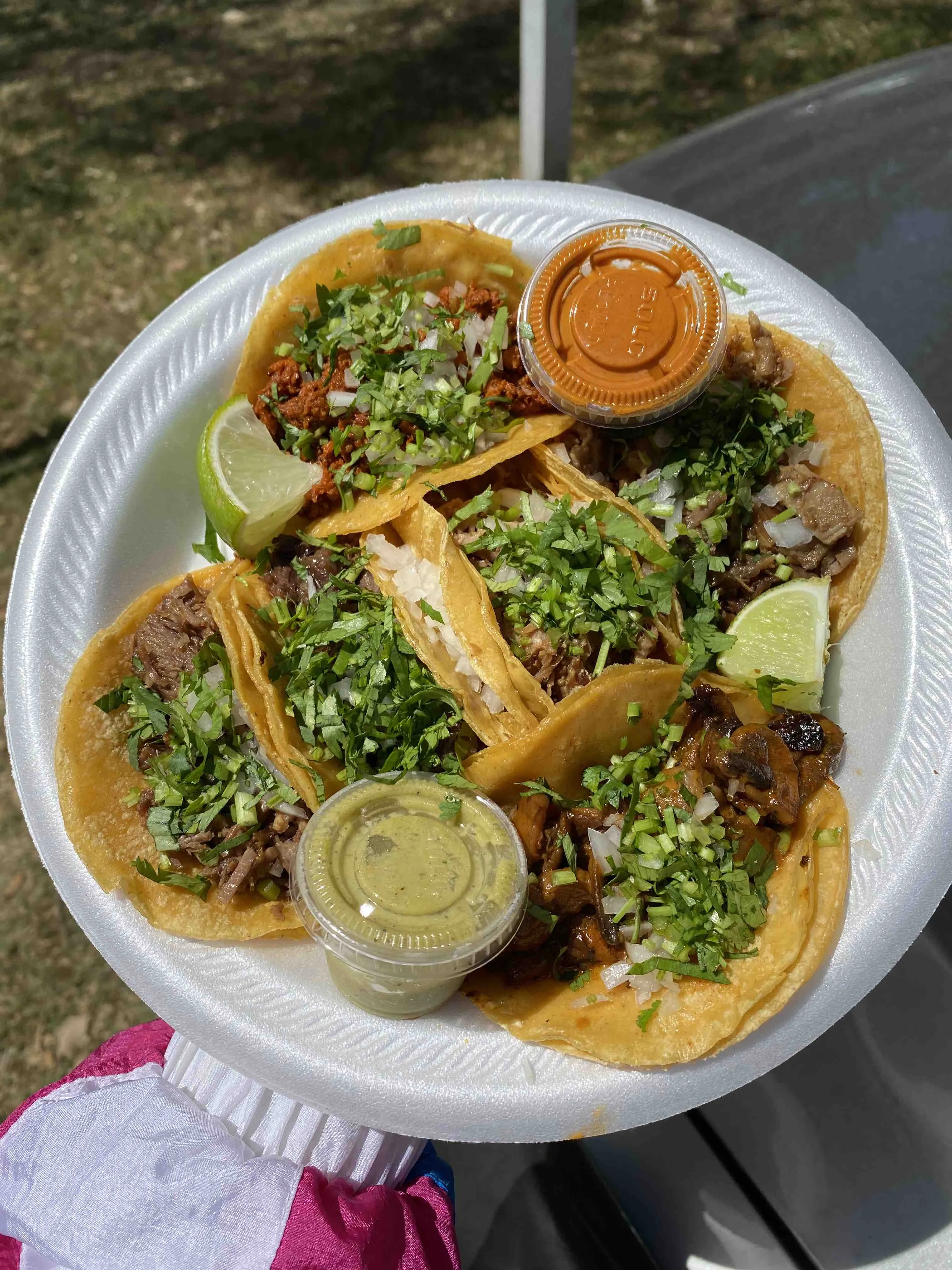 Several small tacos with various fillings on nixtamalized tortillas from Cuantos Tacos in Austin