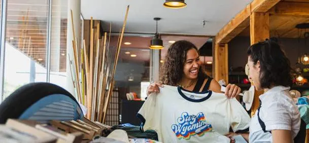 Shopper holding up a Wyoming shirt in a local store