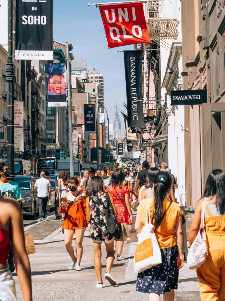 Shoppers exploring boutiques and stores in the SoHo neighborhood of NYC