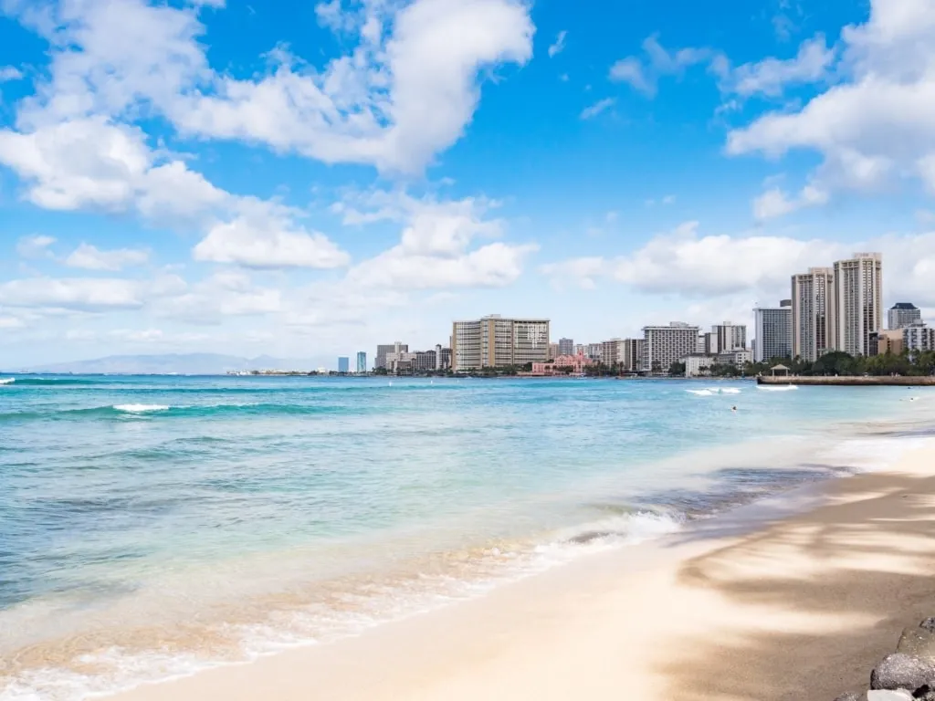 Shoreline of Queen’s Surf Beach, known for bodyboarding waves and snorkeling spots, adjacent to other Best Beach In Honolulu options