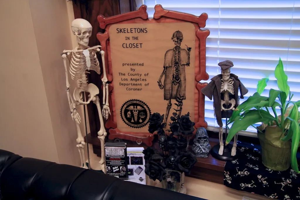Sign reading &quot;Skeletons in the Closet&quot; outside the coroner's office gift shop