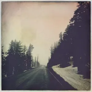 Snow still lingering in summer at Crater Lake National Park, Oregon, experienced by the girl from road trip