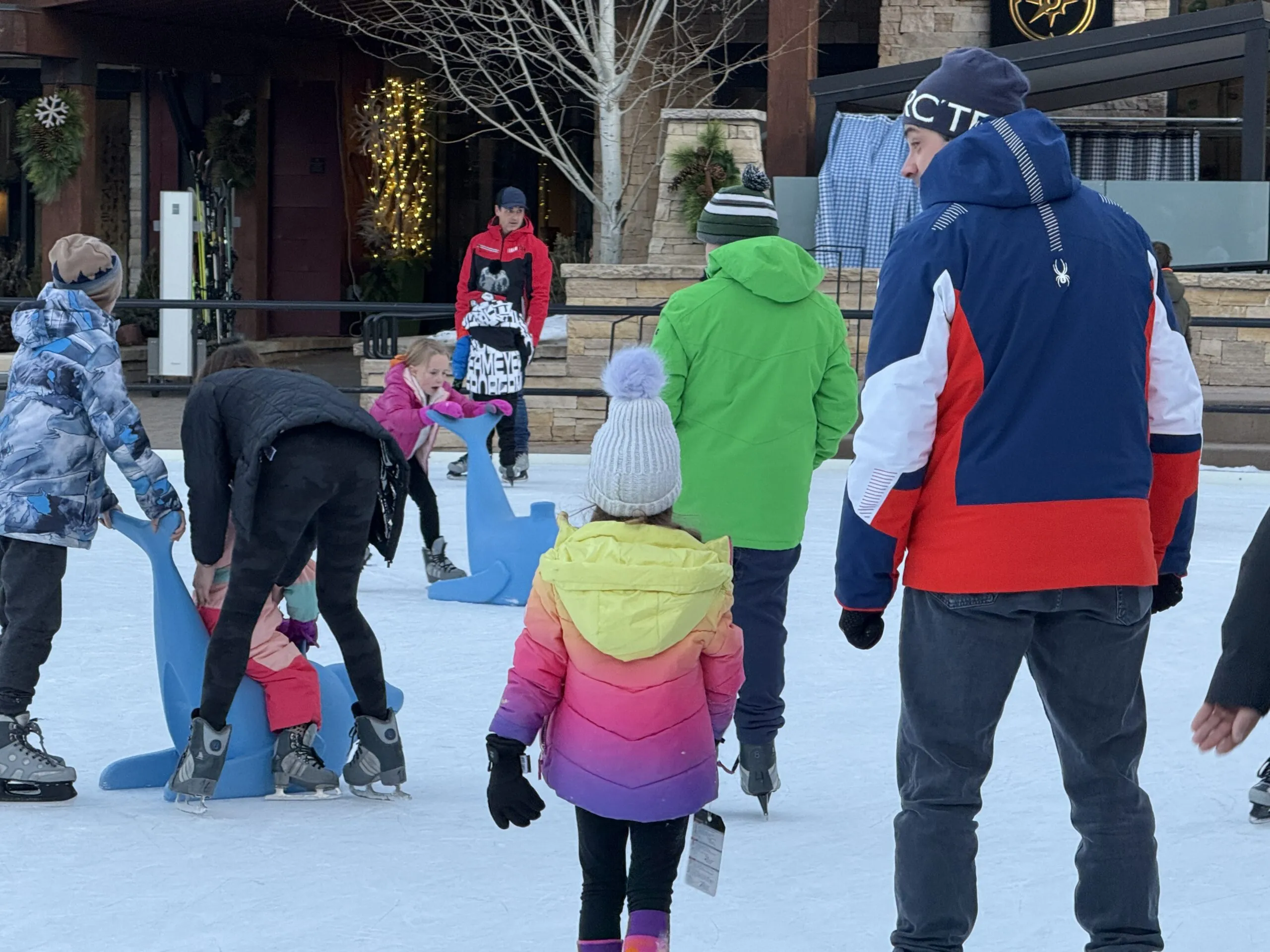 Snowmass Base Village plaza with people enjoying the winter atmosphere