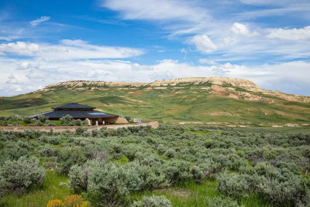 Sprawling view of sagebrush desert, visitor center, and distance rock formations at Fossil Butte National Monument