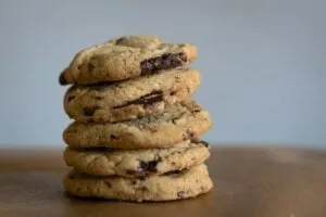 Stack of warm, gooey chocolate chip cookies from Levain Bakery, a must-try unique New York food treat