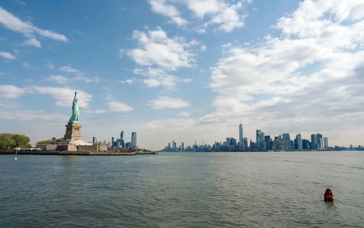 Statue of Liberty seen with the Manhattan and New Jersey skylines