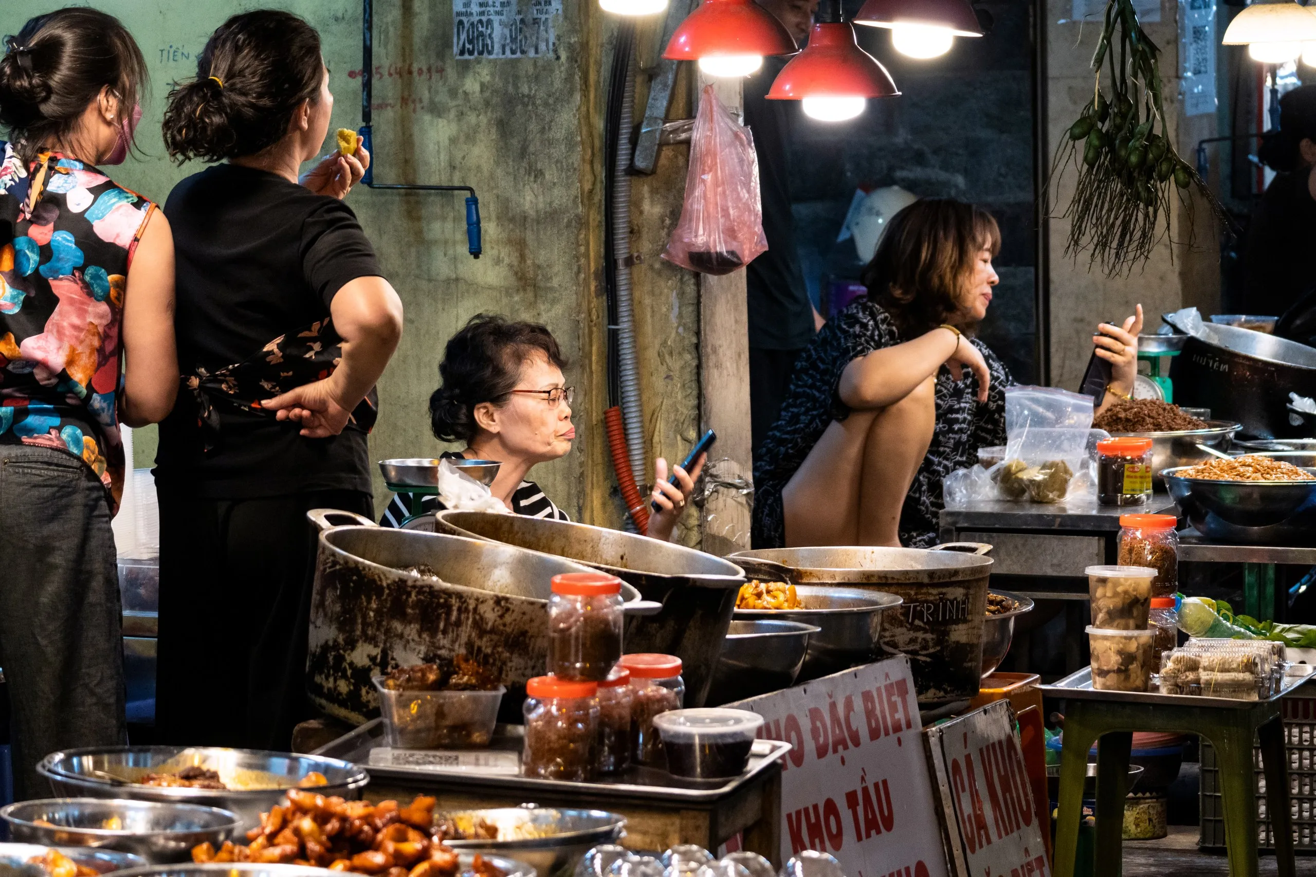 Street food vendors lighting up a night market in Hanoi's Old Quarter - a must experience when deciding where to go in Vietnam.
