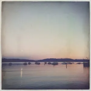 Sunset over Lake Tahoe with boats, a beautiful end to the day for the girl from road trip