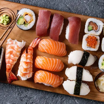 Sushi rolls and nigiri pieces arranged on a plate after being made in a class