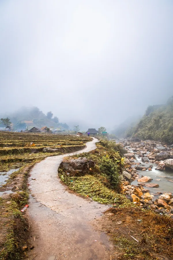 Terraced rice fields and ethnic minority trekkers hiking in Sapa, a cultural experience Backpacking Through Vietnam