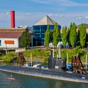 The exterior of OMSI with a submarine docked nearby, highlighting science as one of the fun things to do in Oregon