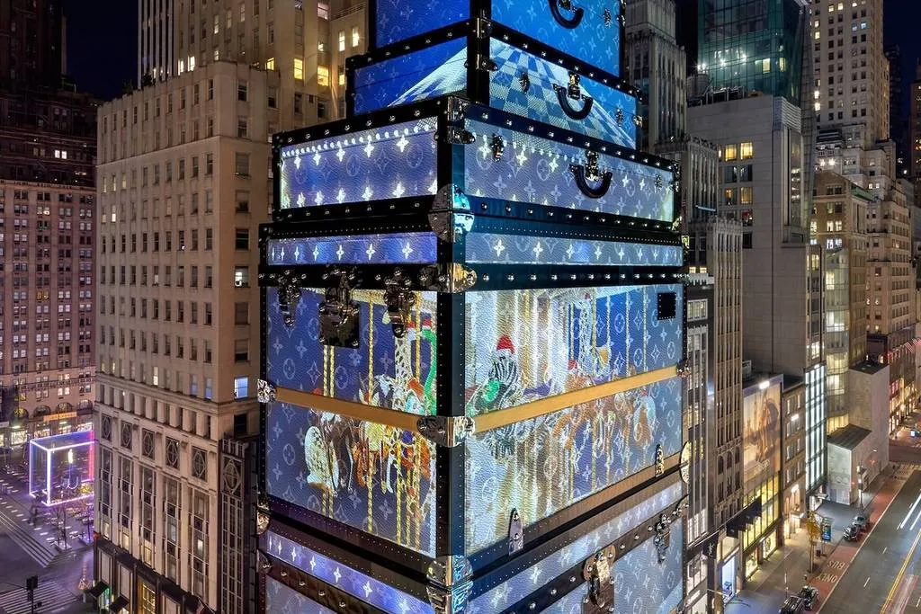 The famous Louis Vuitton store facade on Fifth Avenue is illuminated with a festive holiday light show, showcasing luxury style as part of what to do in NYC in December.