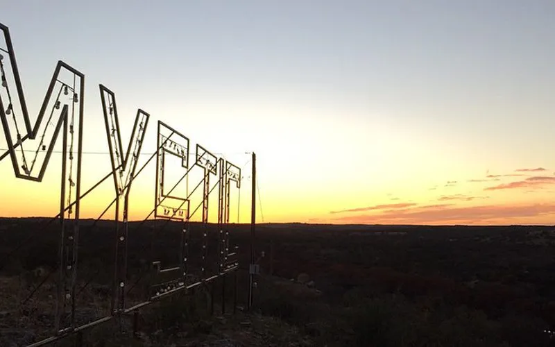 The glowing &quot;Mystic&quot; sign atop Sky High hill at Camp Mystic