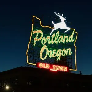 The iconic Portland Oregon &quot;White Stag&quot; neon sign in Old Town Chinatown at twilight