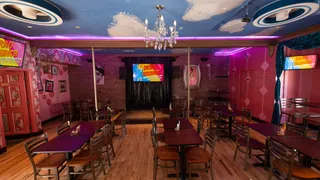 The interior of Hamburger Mary's Denver during an event, showing a stage and seating area, indicative of the lively entertainment found here.