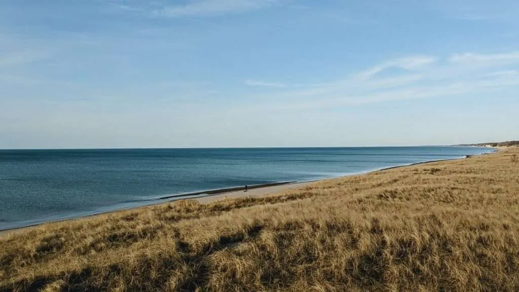 The Lake Michigan shoreline near Indiana Dunes National Park showcases expansive beaches and rolling dunes, a landscape shared with many good places to vacation in Michigan.