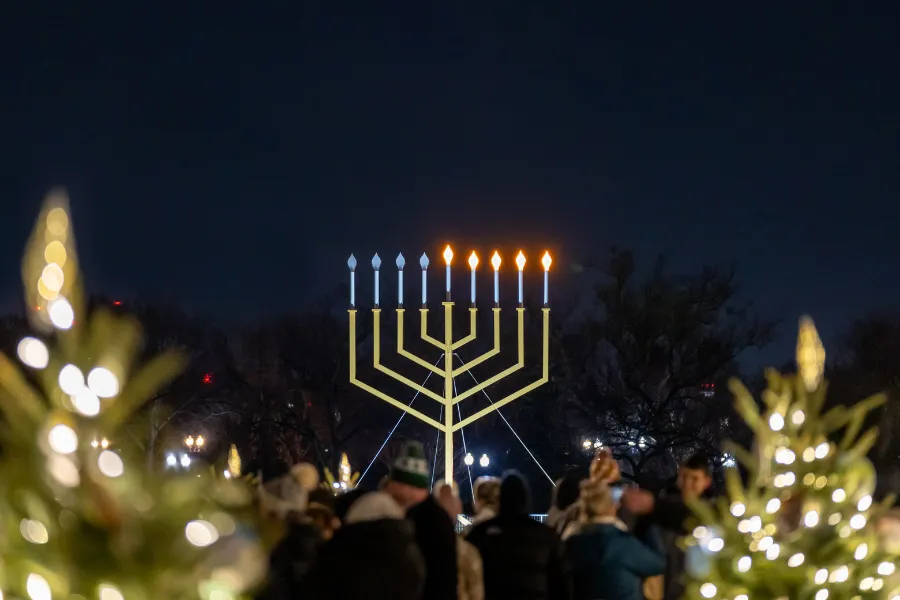 The large National Menorah illuminated, symbolizing Hanukkah celebrations in DC, visible during Travel To Washington Dc In December.