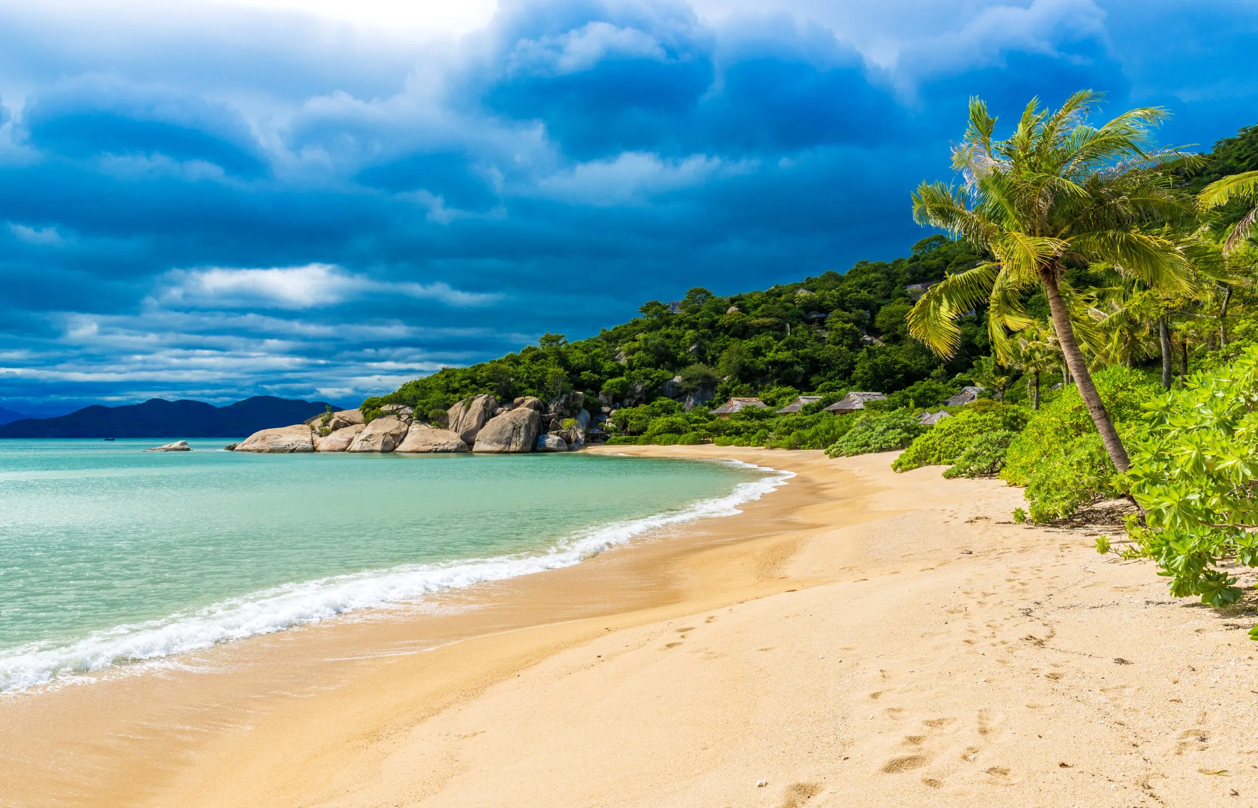The pristine beach and turquoise waters of Ninh Van Bay, a secluded luxury getaway near Nha Trang, Vietnam.
