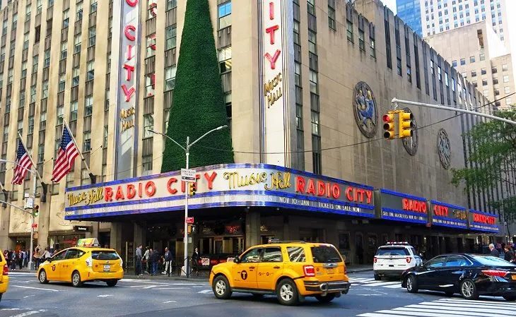 The prominent marquee of Radio City Music Hall in Midtown Manhattan at dusk.