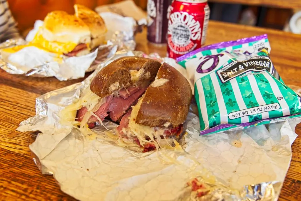 The Ruben sandwich on a pumpernickel bagel with house-cured corned beef from Rosenberg's Bagels, famous for NYC-style brunch in Denver.