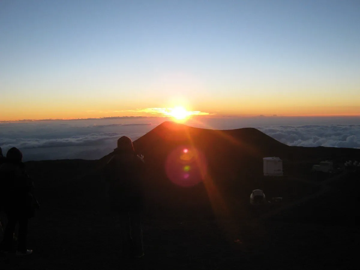 The summit of Mauna Kea on the Big Island during sunset, with observatories visible.