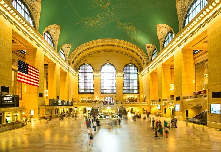 The vast Main Concourse inside Grand Central Terminal with famous clock and celestial ceiling.